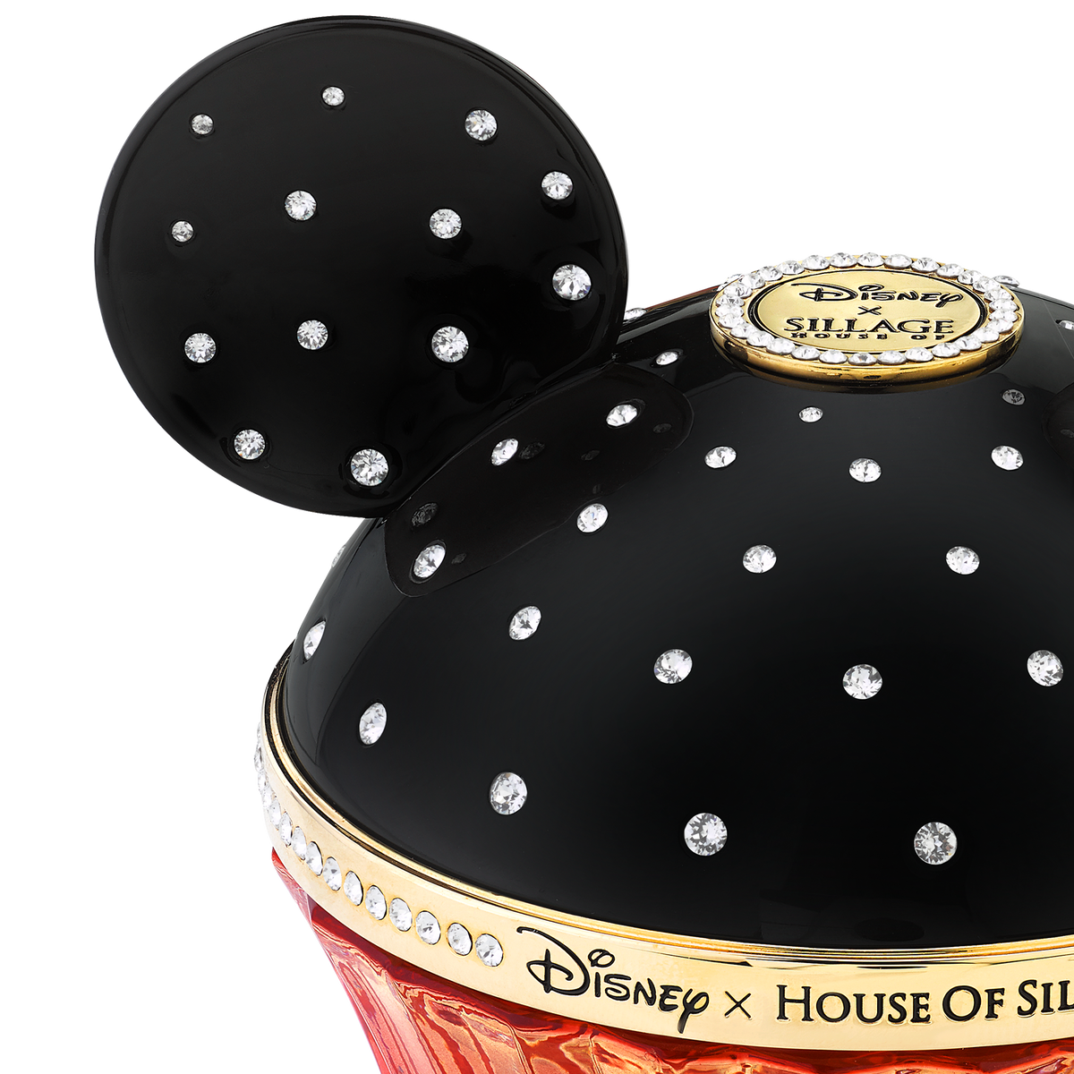 Close-up of a Disney Silver Jubilee collectible container with a glossy black dome decorated with rhinestones, a gold seal, and a red base, on a white background.