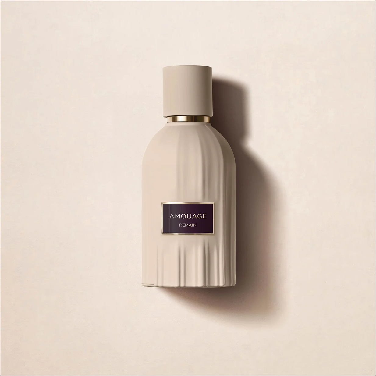 Amouage Remain perfume bottle on a beige background